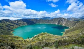 Quilotoa Ecuador lagoon in volcano with turquoise water. Visit beautiful places in the world and enjoy traveling to unique sights.
