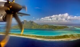 Aerial view of Bora Bora and plane propeller taken from airplane window