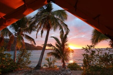 Sonnenuntergang am Strand im Zelt mit Palmen